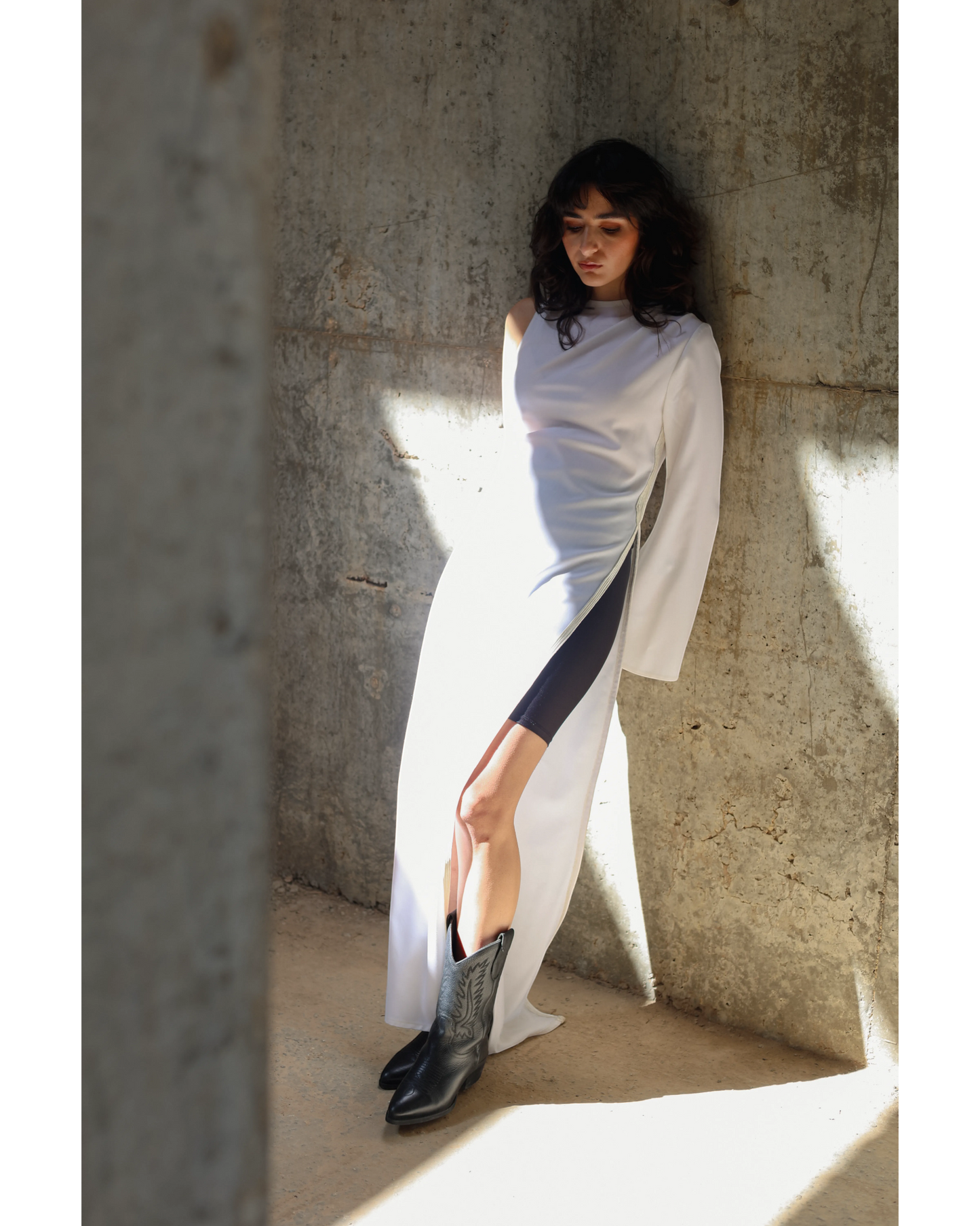 Farah Daylac white cotton one-sleeve dress with a dramatic flared sleeve and high slit, featuring side embroidery.