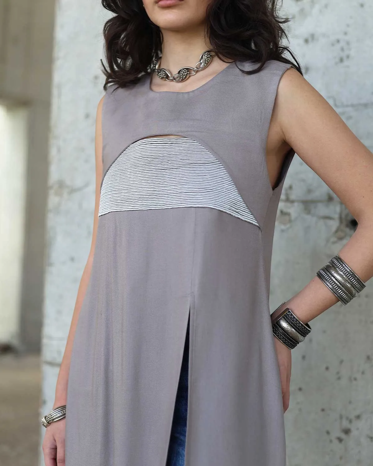 Farah Daylac grey sleeveless dress with embroidered chest panel and front slit. Minimalist design.
