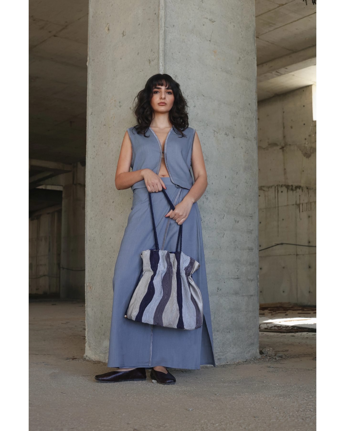 Farah Daylac cream, grey, and navy striped pouch bag with rope handle and gold hardware.