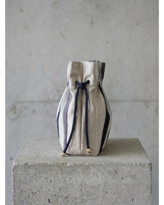 Farah Daylac Topographic Bag: embroidered pouch in navy, grey, sand with rope handles and drawstring closure.